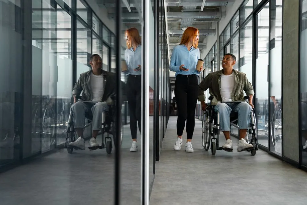 disabled-man-in-wheelchair-working-at-his-office-job (1) (1)