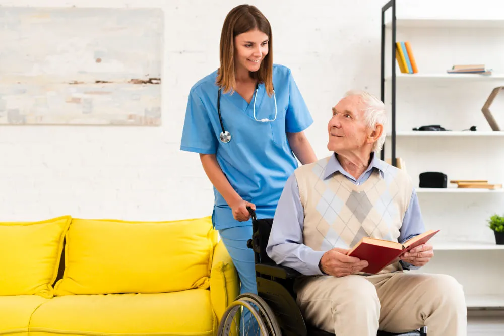 old-man-sitting-on-wheelchair-while-talking-to-nurse (1)