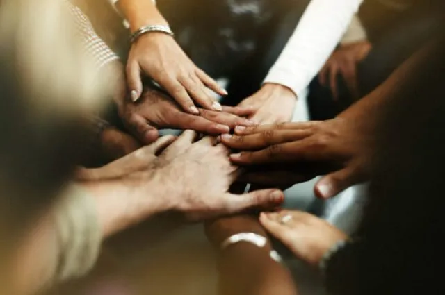 closeup-of-diverse-people-joining-their-hands (1) (1)
