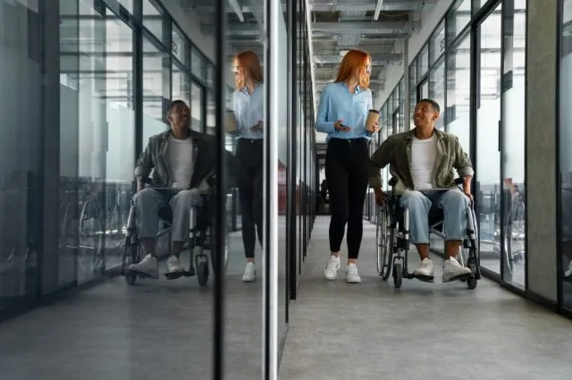 disabled-man-in-wheelchair-working-at-his-office-job (1) (1)