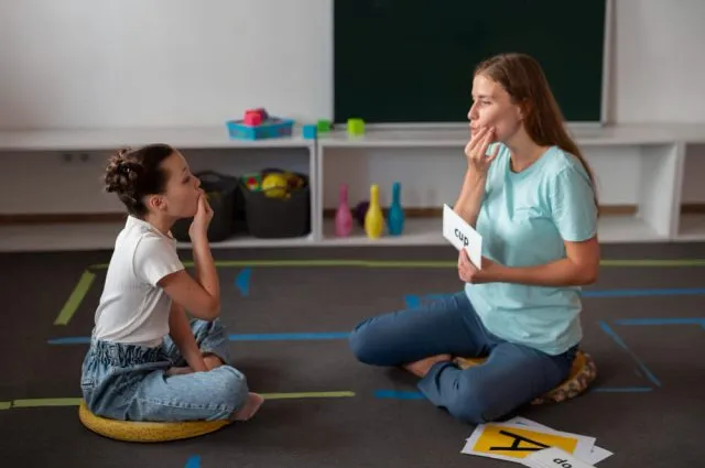 psychologist-helping-girl-in-speech-therapy (1)